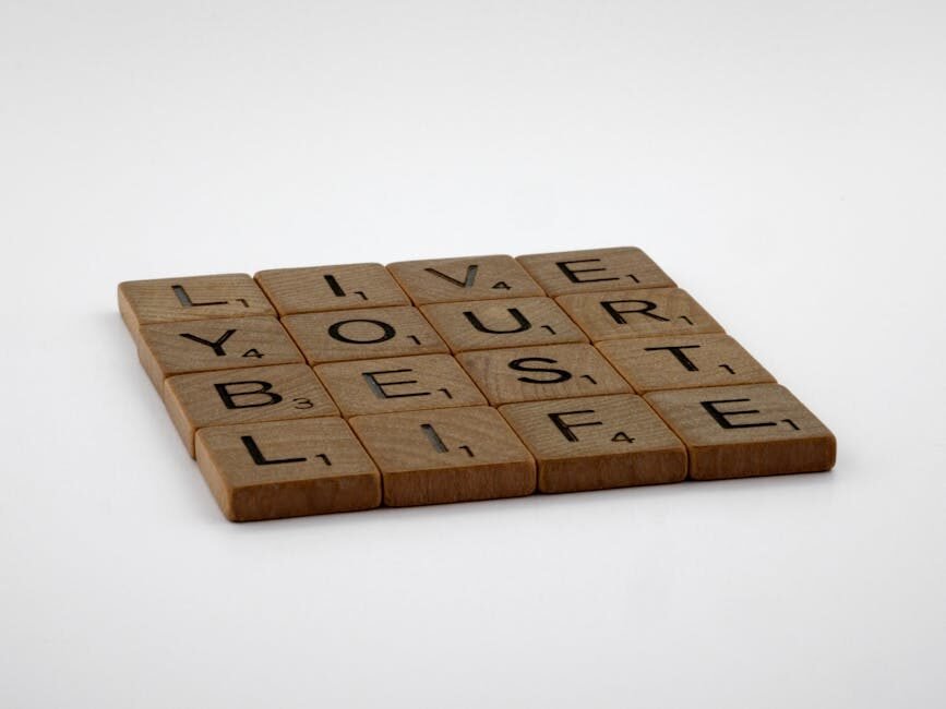 Scrabble tiles spelling 'Live Your Best Life' on a white background.